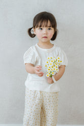 Toddler Sitting on Sofa in Avauma Merry Purp Vanilla Cream Short Sleeve Top, Comfortable Summer T-Shirt for Kids